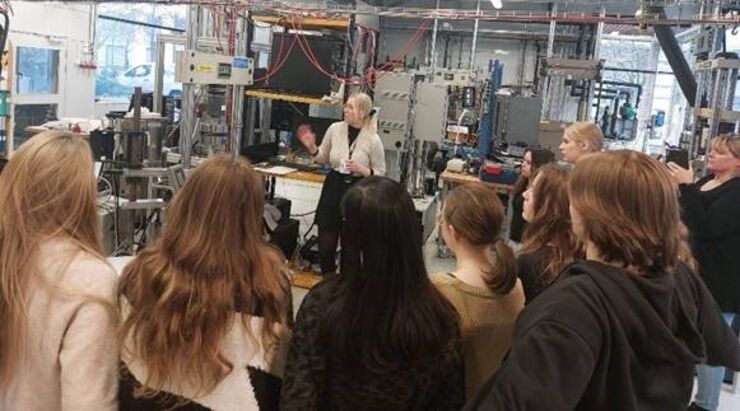 girls listening to a researcher in a lab