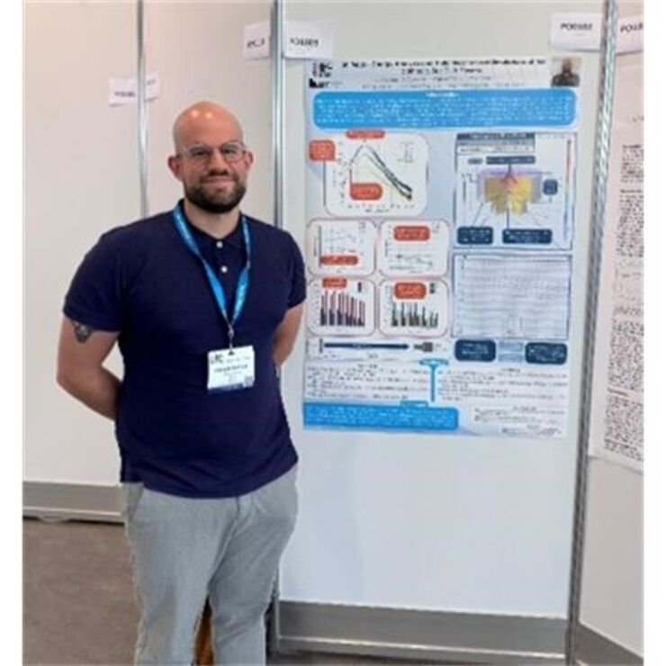 Nikolaos in front of his conference poster.