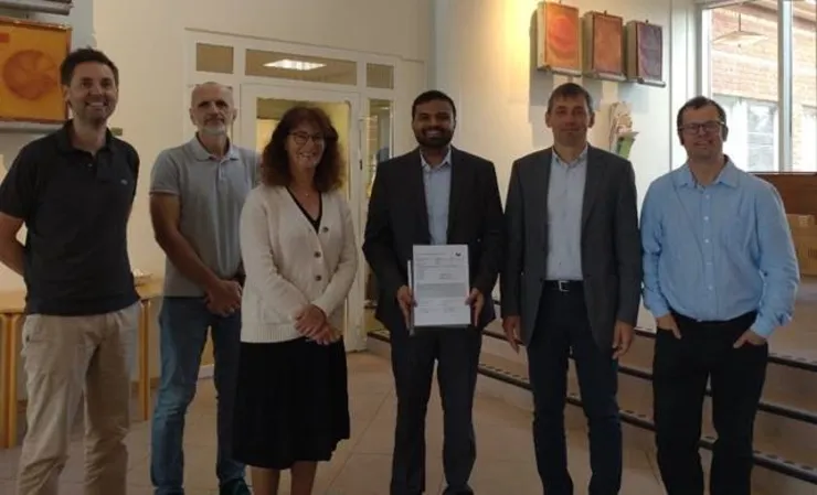group photo of Sanath with his opponent and supervisors